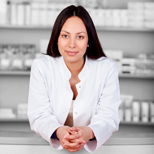 smiling female pharmacist leaning on counter